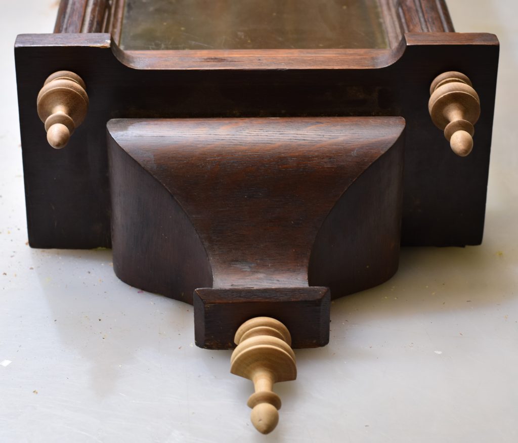Bottom of case with finials
